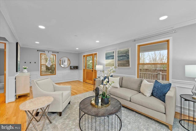 living room featuring crown molding and light hardwood / wood-style floors