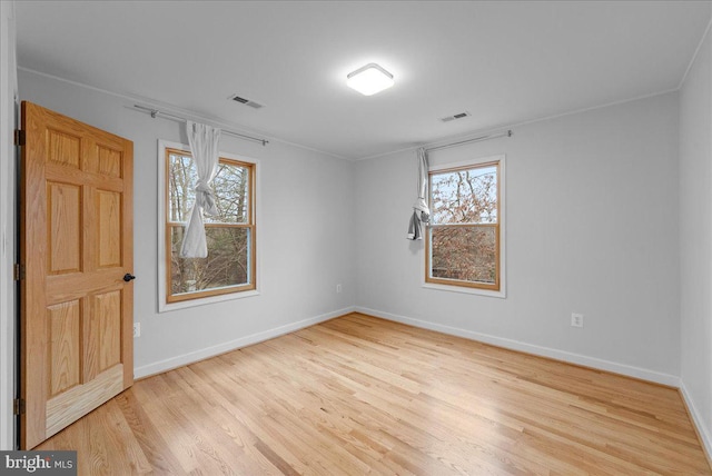 empty room with light hardwood / wood-style flooring