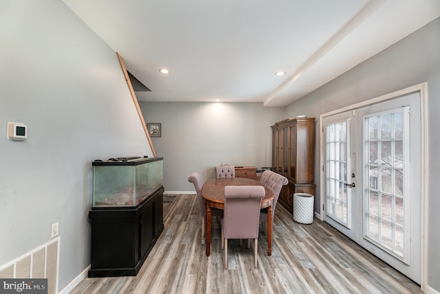 dining space featuring hardwood / wood-style flooring, a healthy amount of sunlight, and french doors