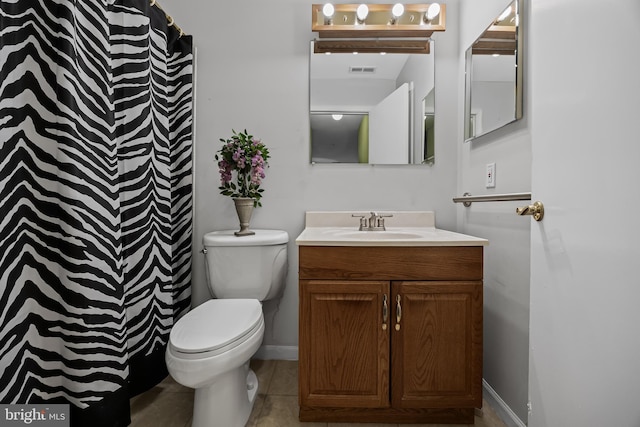 bathroom featuring vanity, toilet, and curtained shower