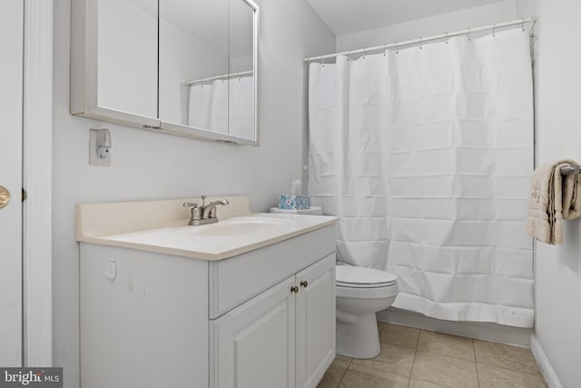 bathroom with tile patterned flooring, vanity, toilet, and walk in shower