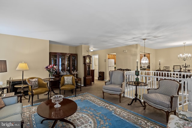 carpeted living room featuring an inviting chandelier