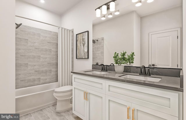 full bathroom with vanity, toilet, and shower / bath combo with shower curtain