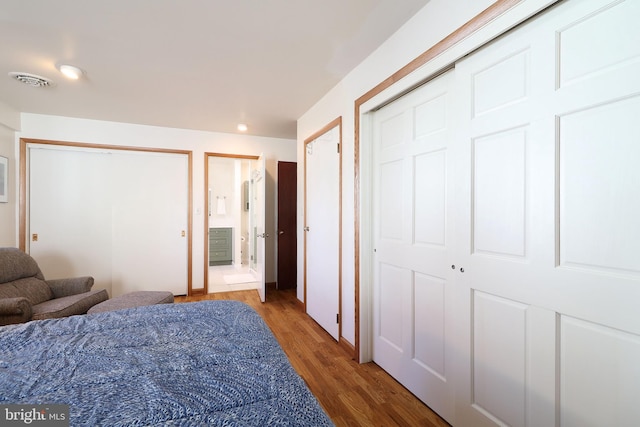 bedroom with hardwood / wood-style flooring