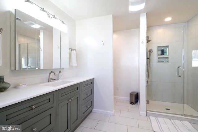 bathroom featuring vanity, tile patterned floors, and a shower with shower door