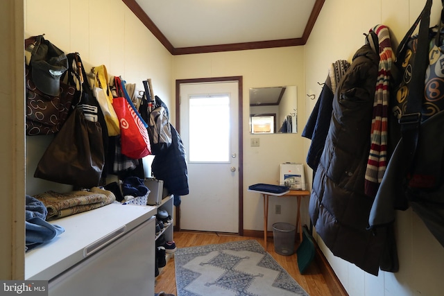 mudroom with ornamental molding and light hardwood / wood-style floors