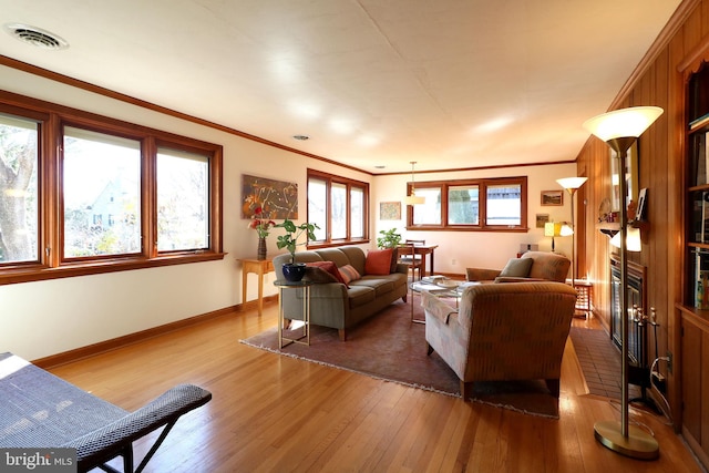 living room with hardwood / wood-style floors and ornamental molding