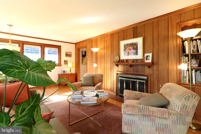 living room featuring crown molding, wooden walls, and dark hardwood / wood-style flooring