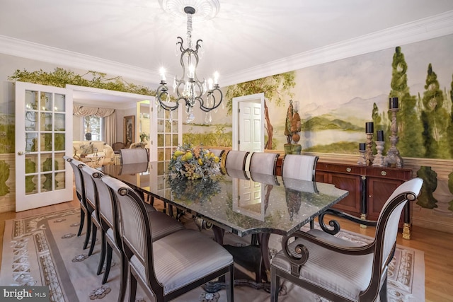 dining area with crown molding, light hardwood / wood-style flooring, and a chandelier