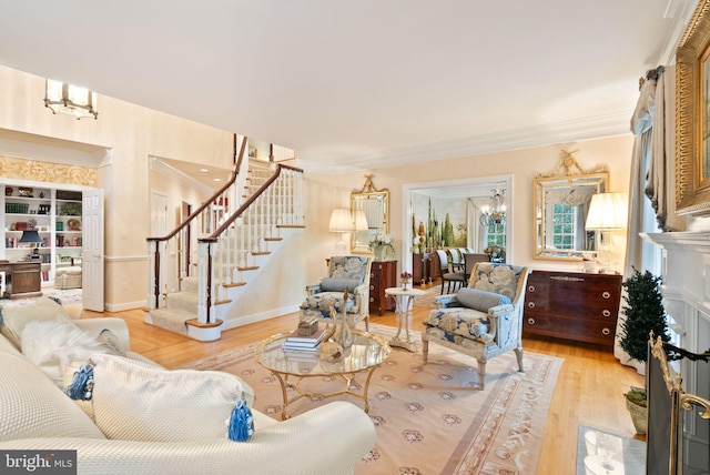 living room featuring ornamental molding and light hardwood / wood-style floors