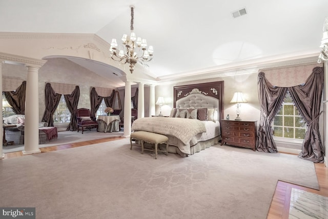 bedroom featuring decorative columns, vaulted ceiling, hardwood / wood-style floors, and crown molding