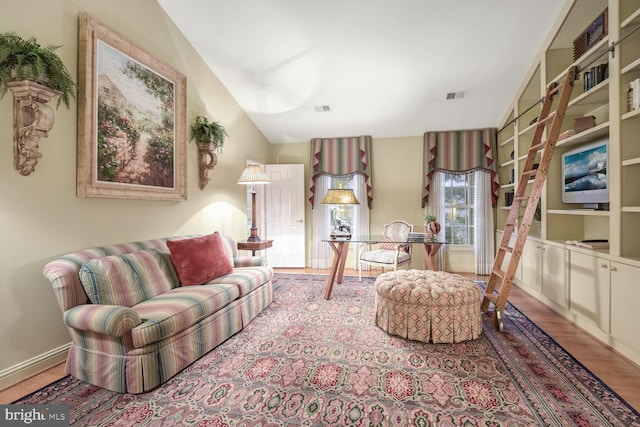 living room with lofted ceiling and light wood-type flooring