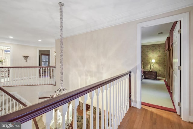 corridor featuring ornamental molding and light wood-type flooring