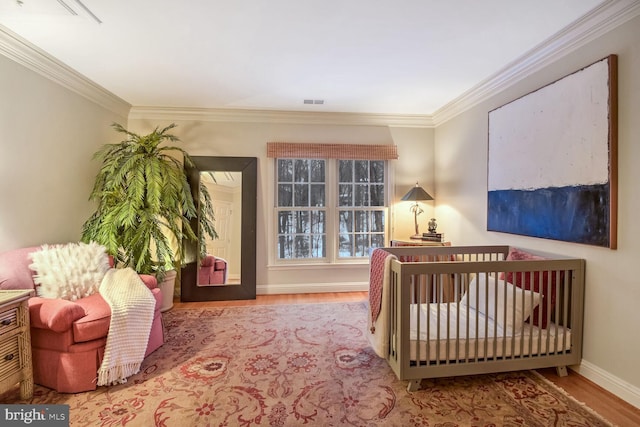 bedroom with crown molding and hardwood / wood-style flooring