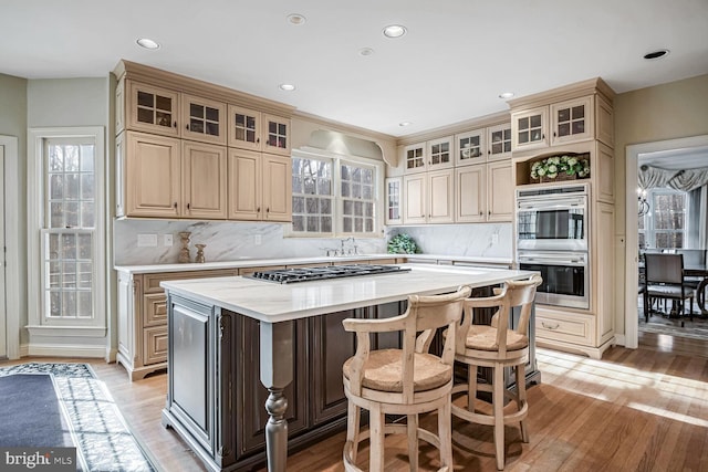 kitchen featuring tasteful backsplash, light hardwood / wood-style floors, and a kitchen island