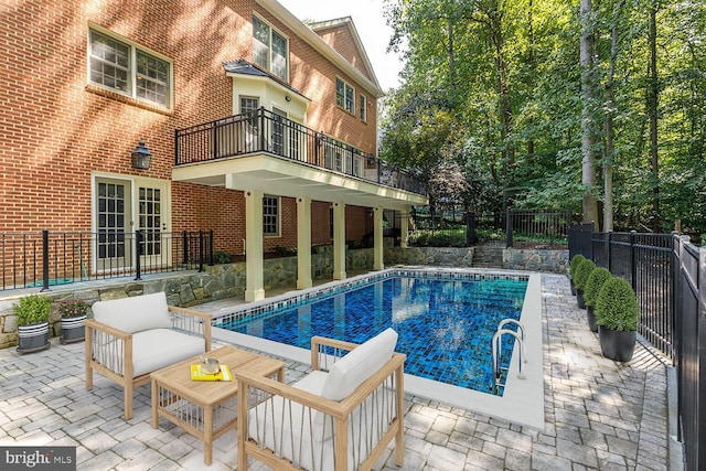 view of swimming pool featuring a patio area