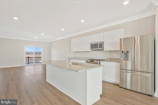 kitchen featuring a kitchen island with sink, stainless steel appliances, white cabinets, and light wood-type flooring