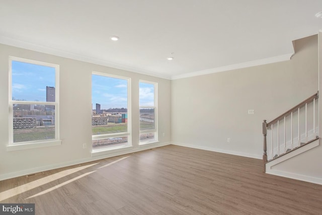 spare room with crown molding and hardwood / wood-style floors