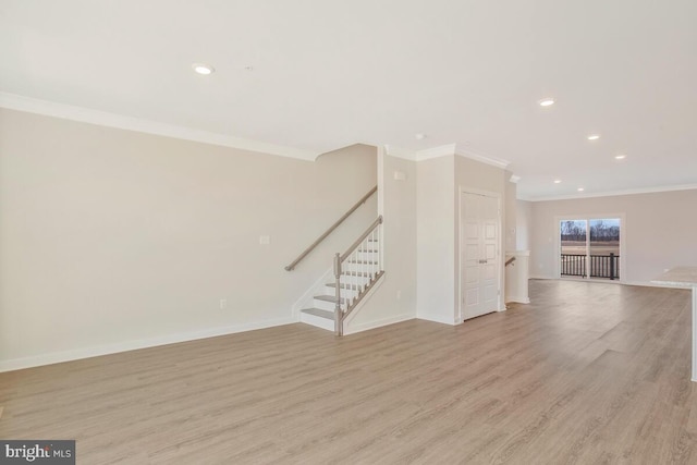 unfurnished living room with ornamental molding and light hardwood / wood-style flooring