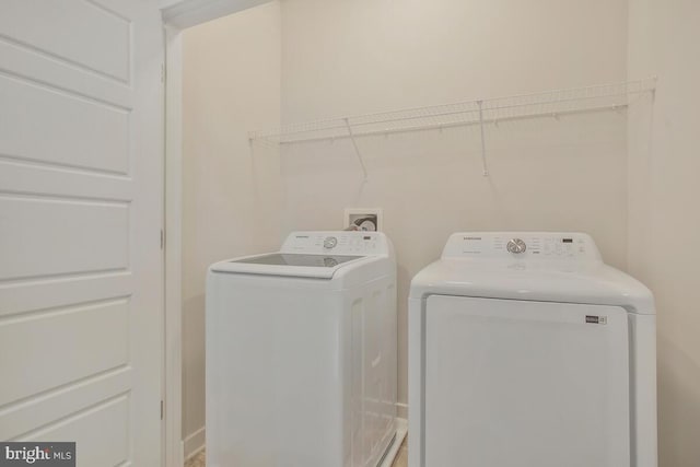 washroom with washing machine and clothes dryer