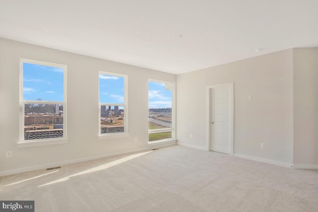 spare room with light colored carpet