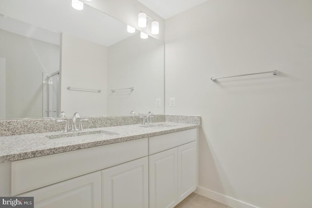 bathroom with vanity, a shower with shower door, and tile patterned flooring