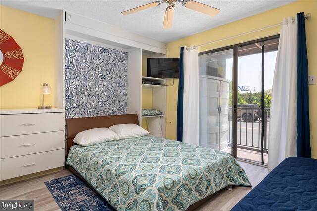 bedroom with ceiling fan, light hardwood / wood-style flooring, and access to outside