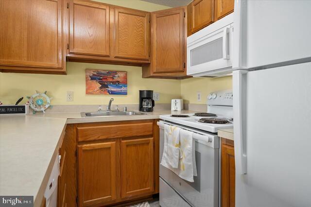 kitchen with sink and white appliances