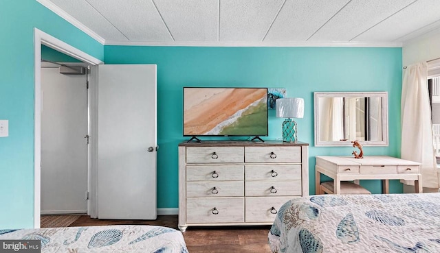 bedroom featuring ornamental molding, a textured ceiling, and dark hardwood / wood-style flooring