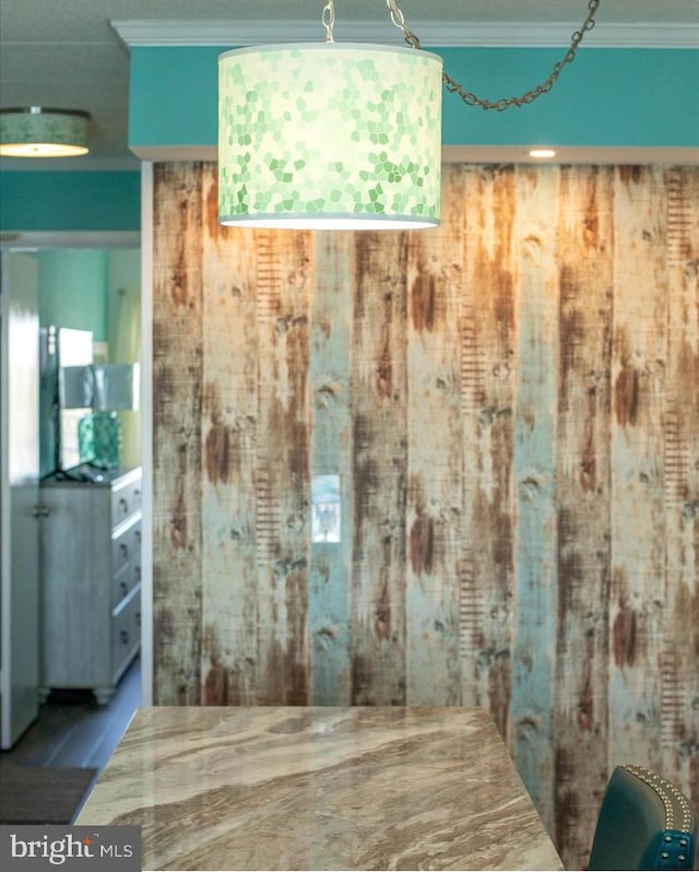 room details featuring wooden walls and ornamental molding