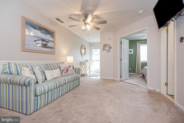 living room featuring a healthy amount of sunlight, carpet floors, and ceiling fan