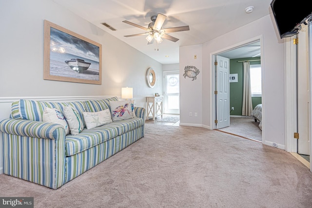 carpeted living room with ceiling fan