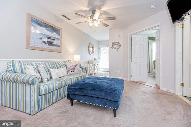 carpeted living room with ceiling fan