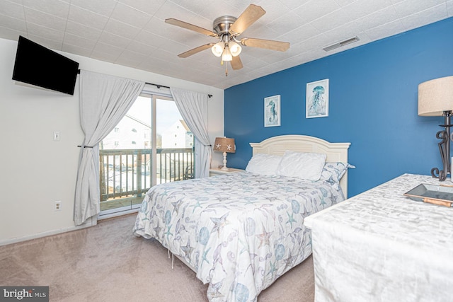 bedroom with light colored carpet, access to exterior, and ceiling fan