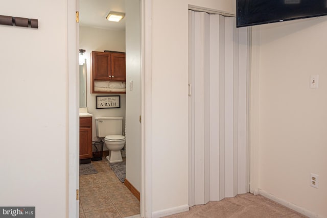 bathroom with vanity, tile patterned flooring, and toilet