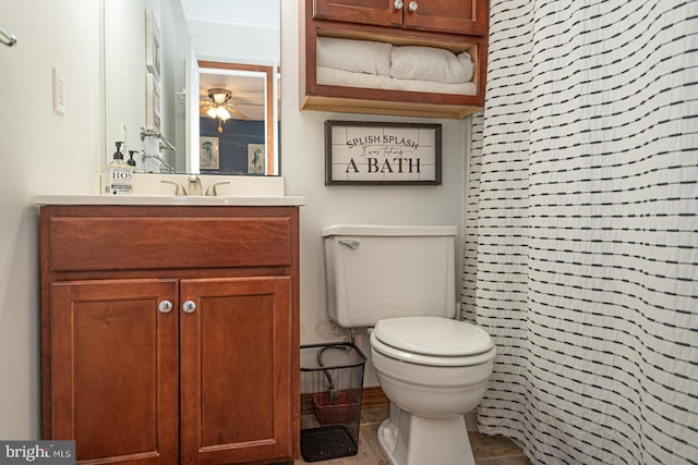 bathroom featuring walk in shower, vanity, and toilet