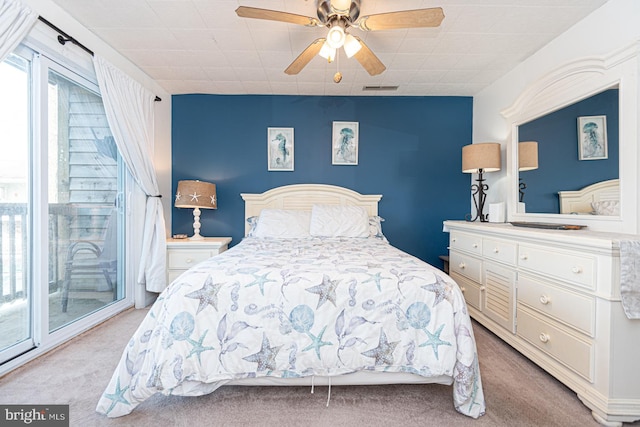 carpeted bedroom featuring access to exterior and ceiling fan