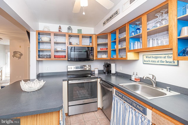 kitchen with ceiling fan, appliances with stainless steel finishes, sink, and light tile patterned floors