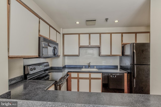 kitchen featuring white cabinetry, sink, and black appliances