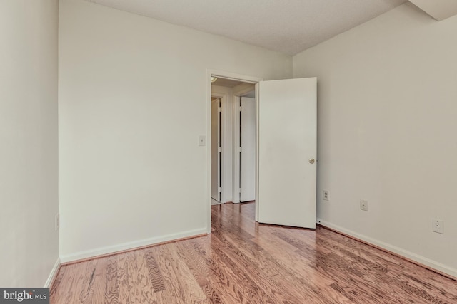 empty room with light hardwood / wood-style flooring