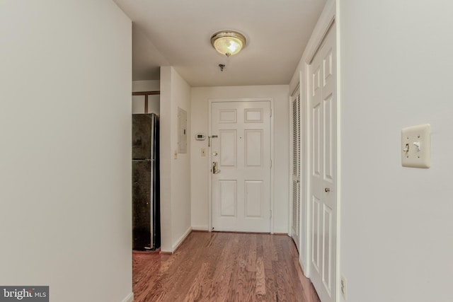 corridor featuring hardwood / wood-style flooring and electric panel