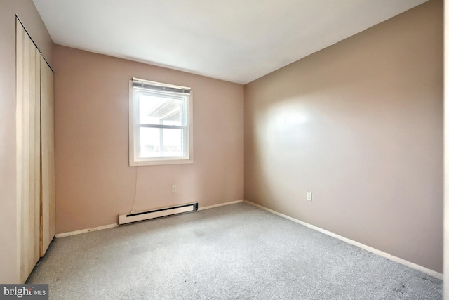 carpeted spare room with baseboard heating