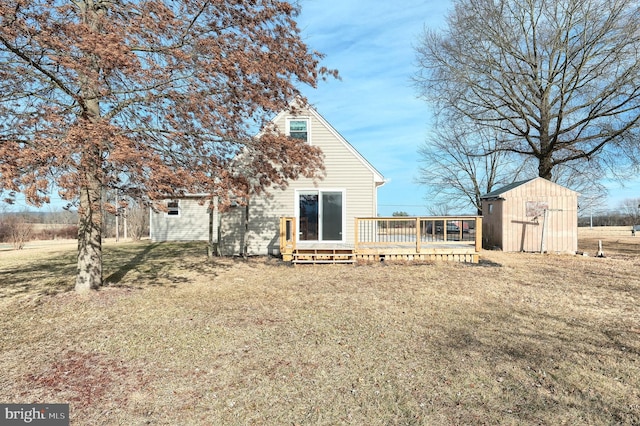 rear view of house featuring a storage shed, a yard, and a deck