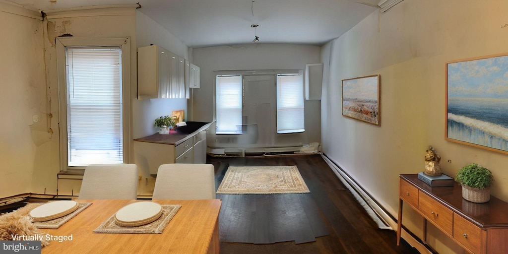 entryway with dark hardwood / wood-style floors and baseboard heating