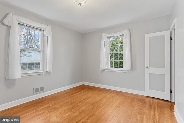 spare room with light hardwood / wood-style floors