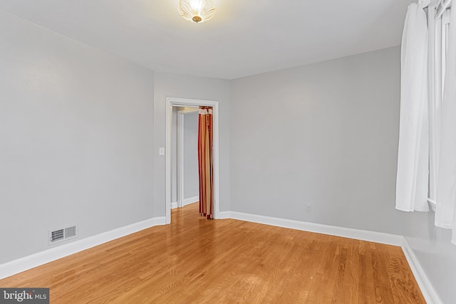 empty room with hardwood / wood-style flooring