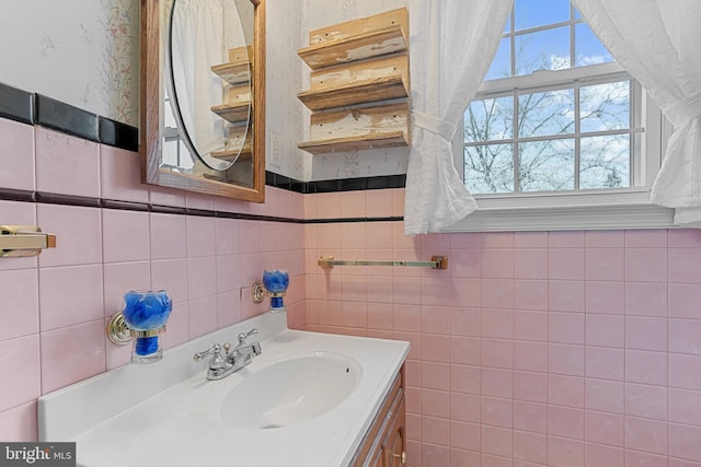 bathroom with vanity and tile walls