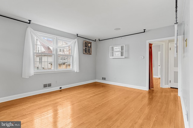 unfurnished room featuring light hardwood / wood-style floors