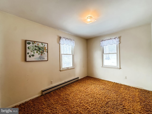 carpeted spare room with plenty of natural light and a baseboard radiator