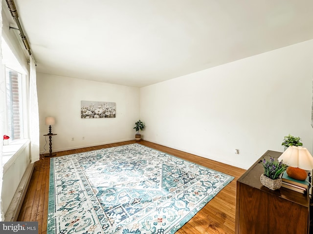 interior space featuring baseboards and wood finished floors